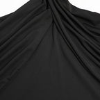 Close-up of black fabric with folds on a white background